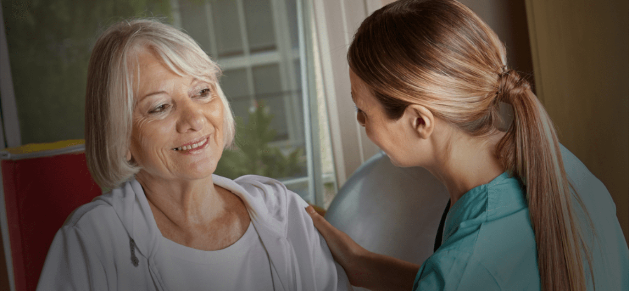 a nurse and an old woman smiling